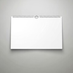 Blank horizontal wall calendar with spiral binding and hanging hole isolated on white background