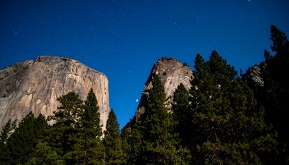 Nighttime landscape of towering granite peaks and a crescent moon