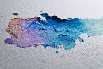 Close-up of textured watercolor blend on rough paper surface in pastel tones.