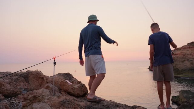 Father and son fishing side by side, sharing tranquil moment during seaside summer getaway