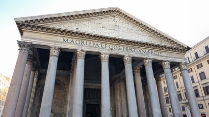 Rome, Italy - 10 January 2025. The Pantheon’s facade displays massive stone columns and the inscription crediting Marcus Agrippa, surrounded by Roman-era and modern buildings.