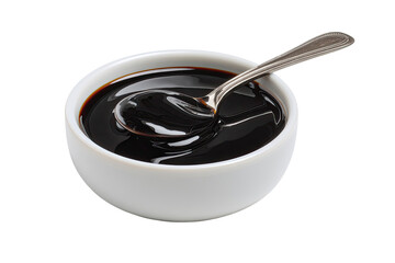 Dark, glossy sauce in a white bowl, with a silver spoon