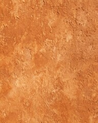 Fototapeta premium A textured surface of reddishbrown earth, displaying a rough and uneven texture, with subtle variations in color and tone, creating a natural and organic background for various applications