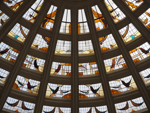 Geometric stained glass dome with bird motifs architecture