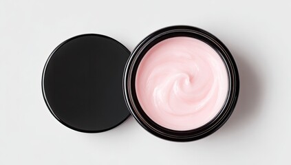 Top-down view of a small, round, pink cream jar with a black lid