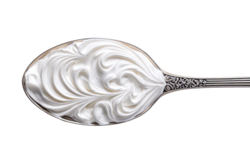 Whipped cream swirls in an ornate spoon