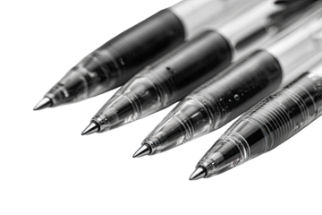 Close-up of four ballpoint pens, tips angled together