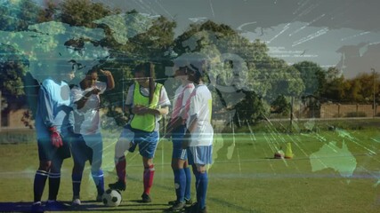 female soccer player tapping phone on pitch activating world map network for sports analysis - Powered by Adobe