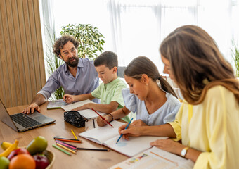 Mom and dad helping kids with schoolwork at home