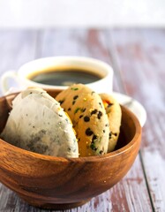Cookies in wooden bowl, coffee cup