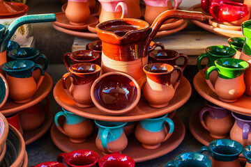 A clay coffee pot and cup set on the market stall.