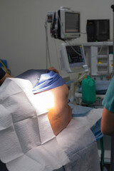 Patient on operating table being sedated before surgery