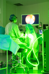 Urologist performing laser surgery with endoscopic guidance in operating room