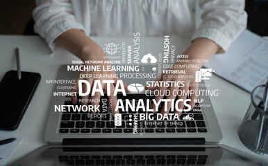 A focused view of hands typing on a laptop covered with cloud computing and data analytics terms, symbolizing the essence of modern business technology and insights. Tessel