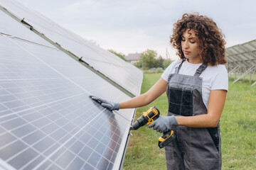 Female Technician Installing Solar Panel in Green Field