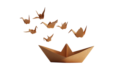 Origami cranes ascending from a paper boat