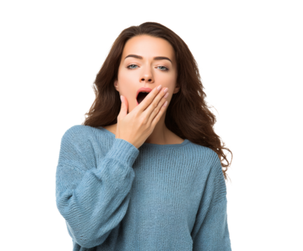 A young woman yawns while covering her mouth with her hand.