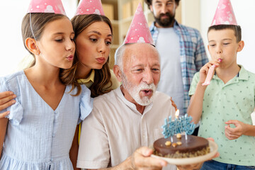 Family gathers to celebrate a birthday with cake