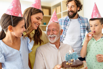 Family gathers to celebrate a birthday with cake