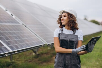 Female engineer working with digital tablet in a solar power station