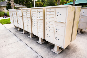 Group of outdoor community mailboxes in residential neighborhood for postal delivery, housing services, and shared mail distribution.