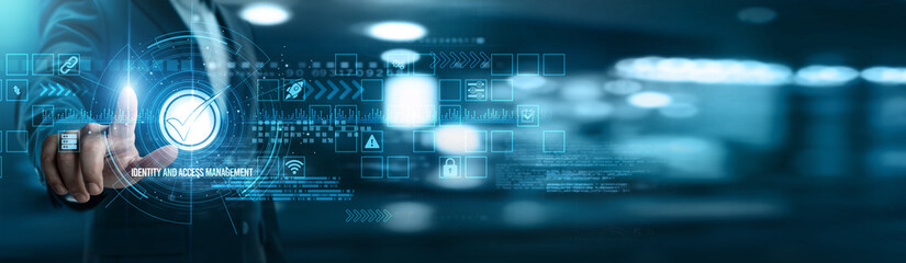 Fototapeta premium Businessman touching identity and access management networking and authentication systems, user permissions, biometric verification, security protocols, compliance monitoring, role-based access