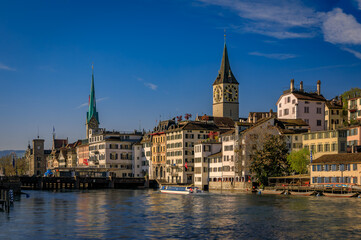 Fototapeta premium Cityscape with historic buildings and churches on the Limmat, Zurich Switzerland
