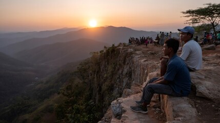 Tourists admiring breathtaking sunset over mountain valley in southeast asia