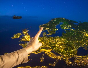 Hand pointing at Europe at night