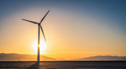 Obraz premium Wind turbine farm prominently in the foreground, set against a landscape that features a flat, expansive terrain with mountains in the background.