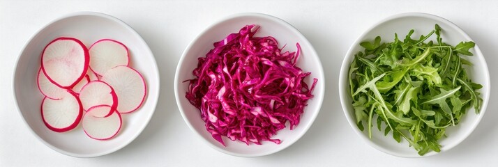 Fototapeta premium Sliced radishes, shredded cabbage, and arugula displayed in bowls for a fresh salad preparation