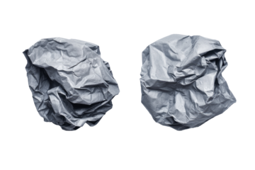 Two crumpled gray paper balls against a black background