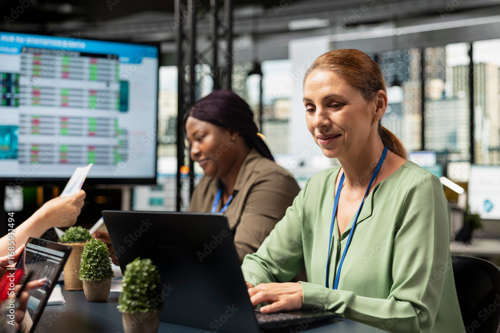 Poster ambitious focused businesswoman at desk reviewing business strategy after collecting reports data an