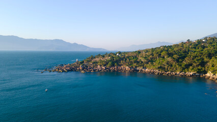 Fototapeta premium Aerial view of tropical coastline with forest and rocky shore in Brazil