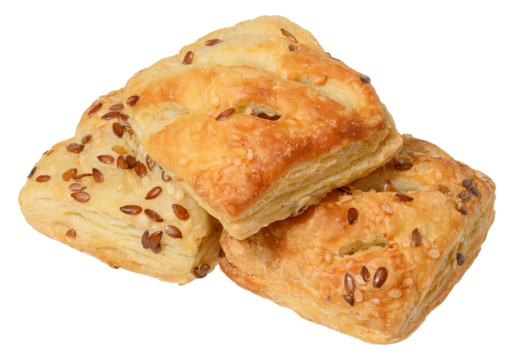 Ruddy puff pastry buns sprinkled with seeds stacked in a pyramid. Baking on an isolated background
