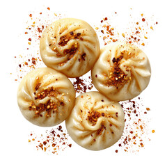 Four steamed buns, a close-up view, topped with a sprinkle of spice