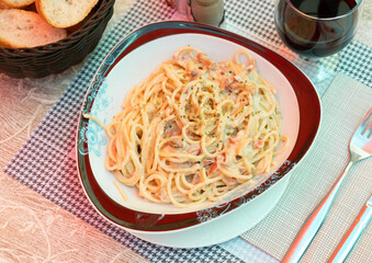 Carbonara pasta, spaghetti with pancetta, hard parmesan cheese and cream sauce. Traditional italian cuisine