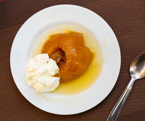 Sweet baked apple in caramel served on platter for dessert