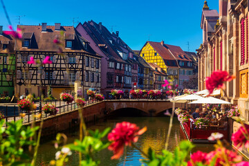 View of Little Venice, picturesque blooming old tourist area in historic center of Colmar city along canals of Lauch river on summer day, France