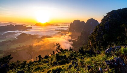 Fototapeta premium Sunrise over misty mountain valley