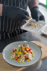 The chef lays out the salad. 