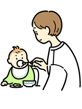赤ちゃんに離乳食を与える女性