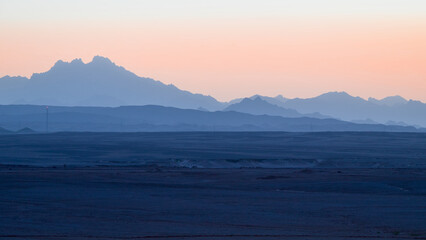 View from a hotel window near Marsa Alam, Egypt, towards inland mountains after sunset.