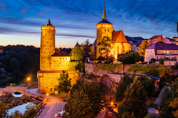 Bautzen with illuminated tower and church at night mood under blue sky