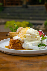 Delectable French toast with fresh fruit, ice cream, and mint, perfect for brunch or dessert
