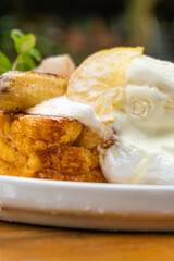 Delicious French toast with caramelized banana, lemon and vanilla ice cream dessert