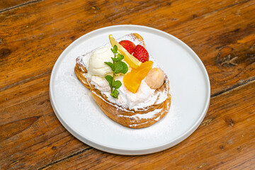 Delicious gourmet dessert with fresh fruit, ice cream, and mint, perfect for food blogs