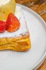 Delicious French toast with strawberries and lemon creating a perfect breakfast treat