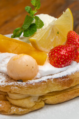 Delectable brunch waffle with fresh berries, fruit, and cream for a sweet indulgence