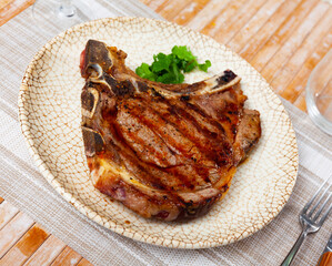 Dish made from whole piece of meat is fried beef entrecote cooked over open fire. Roast veal tenderloin, decorated with sprig of parsley.